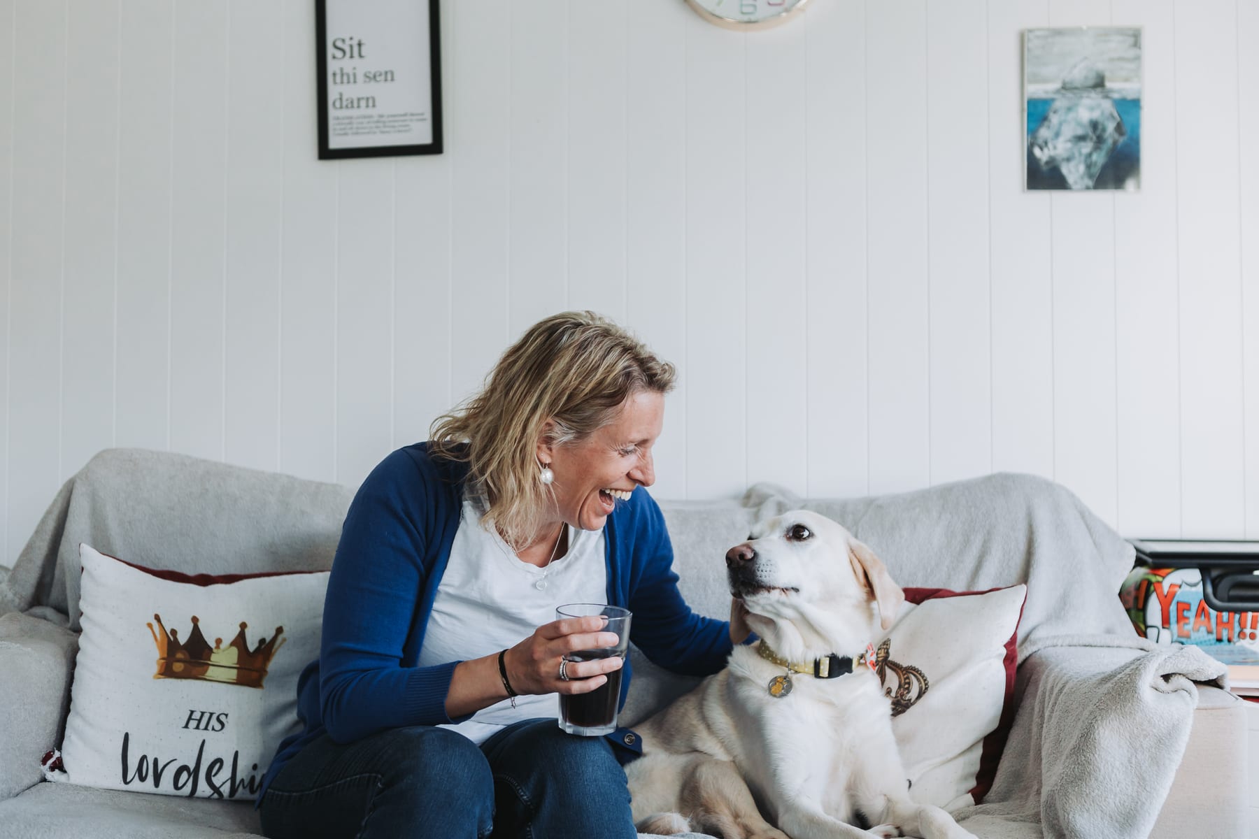 Dr Helen Ross laughing with her dog at home